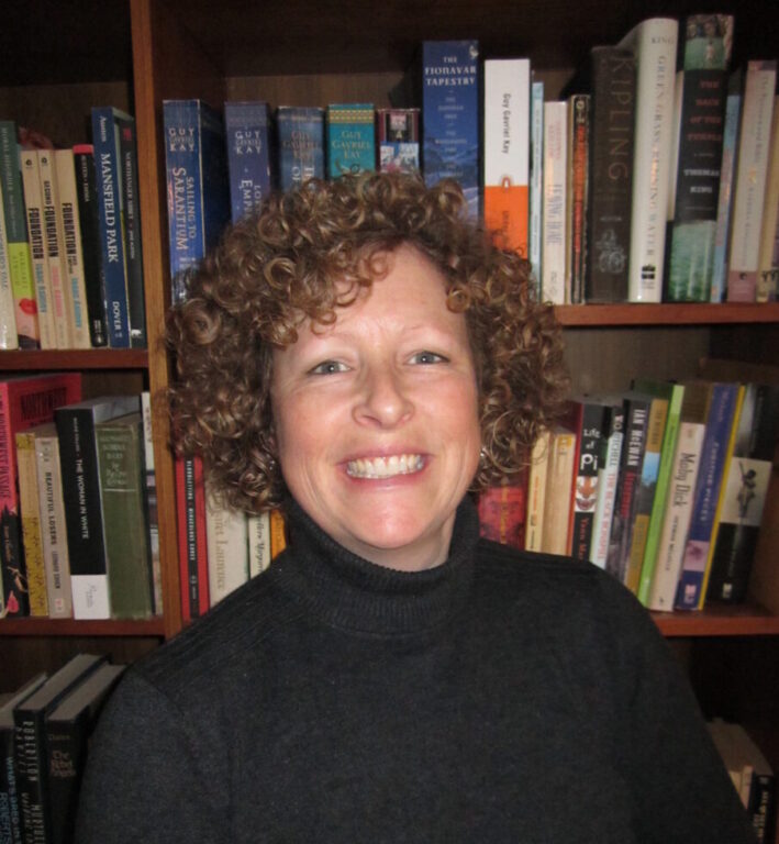 Nancy Payne Headshot in front of bookcase