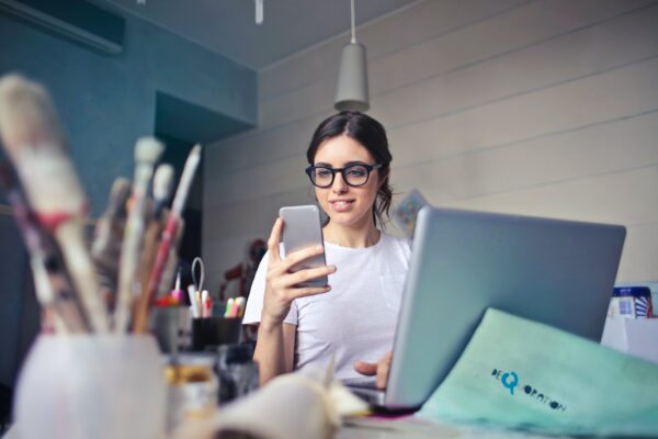 Young woman at a desk on her phone